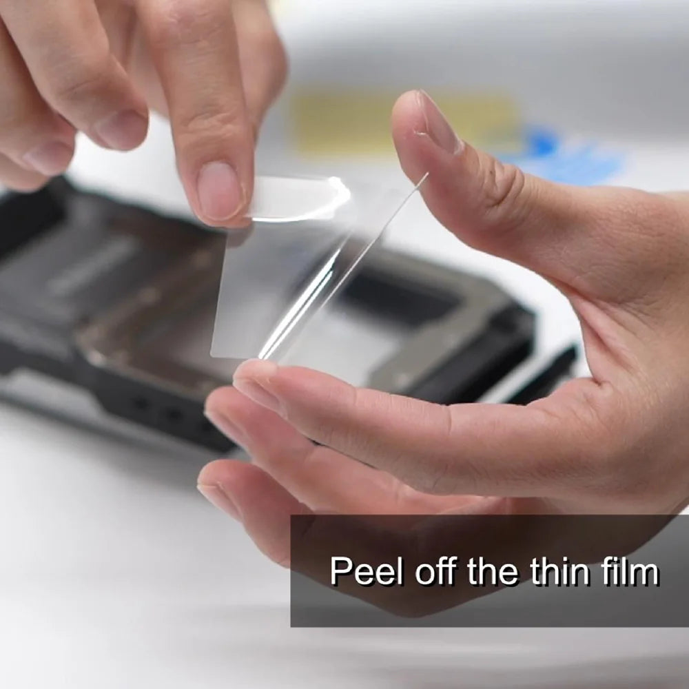 Peeling the backing from Divevolk SeaTouch 4 MAX glass protective film before fitting